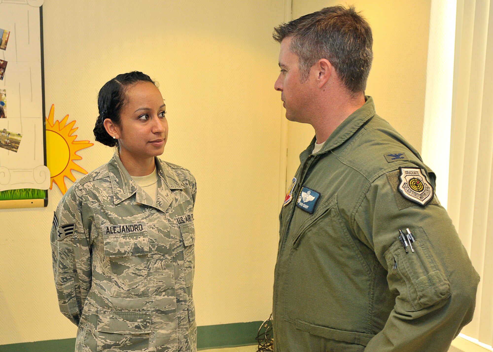 Senior Airman Sasha Alejandro, 325th Force Support Squadron force management technician speaks with Col. David E. Graff, 325th Fighter Wing commander Oct. 25 at Chapel 2. Colonel Graff congratulates Airman Alejandro for the successful turnout of the Hispanic Heritage Month luncheon. (U.S. Air Force photo by Airman 1st Class Sergio A. Gamboa)