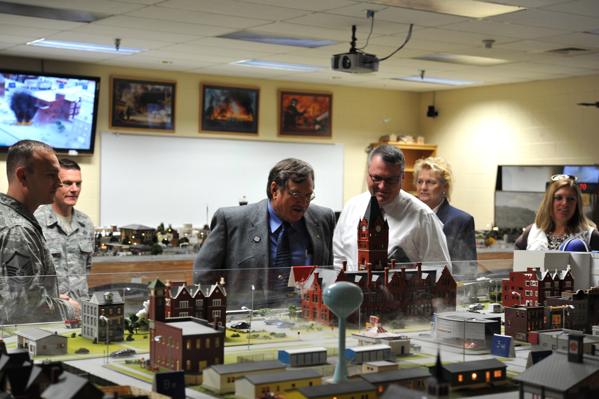 GOODFELLOW AIR FORCE BASE, Texas-- The Honorable Dwain Morrison, Mayor of San Angelo, Texas, and Rodney Fleming, San Angelo City Council member, watch as smoke plumes out of the Command and Control Simulations Trainer at the Louis F. Garland Department of Defense Fire Academy Oct. 25. Mayor Morrison visited Goodfellow to tour the 17th Training Wing and to learn about the wing’s mission. (U.S. Air Force photo/ Senior Airman Michael Smith)