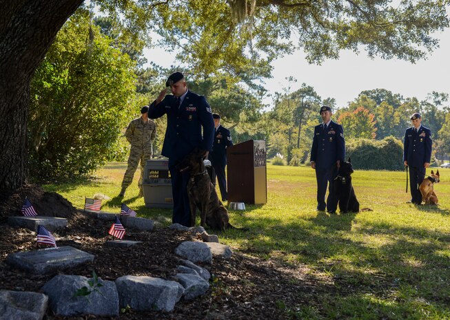 The 628th Security Forces Squadron Airmen hold a burial ceremony for military working dog Athos on Oct. 24, 2013, at Joint Base Charleston – Air Base, S.C. Athos was born Aug. 1998 and passed away Oct. 2012. Athos served as an explosive detector dog for 11 years. He was returned to JB Charleston where his ashes were buried alongside his fellow military working dogs. (U.S. Air Force photo/ Airman 1st Class Chacarra Neal)