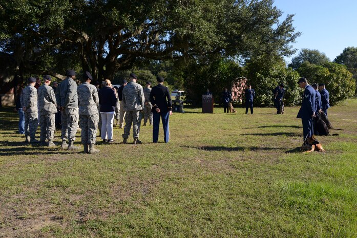 The 628th Security Forces Squadron Airmen hold a burial ceremony for military working dog Athos on Oct. 24, 2013, at Joint Base Charleston – Air Base, S.C. Athos was born Aug. 1998 and passed away Oct. 2012. Athos served as an explosive detector dog for 11 years. He was returned to JB Charleston where his ashes were buried alongside his fellow military working dogs. (U.S. Air Force photo/ Airman 1st Class Chacarra Neal)