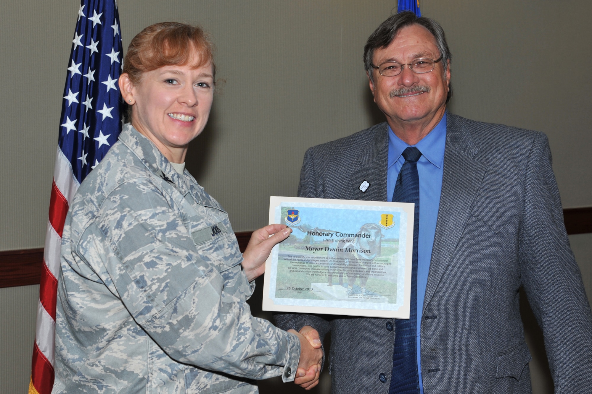 GOODFELLOW AIR FORCE BASE, Texas-- Col. Kimberlee Joos, 17th Training Wing Commander, presents the Honorable Dwain Morrison, Mayor of San Angelo, Texas, with his Honorary Commander Certificate Oct. 25. The program brings honorary commanders and their military counterparts together to actively communicate and exchange ideas in their areas of expertise. (U.S. Air Force photo/ Senior Airman Michael Smith)