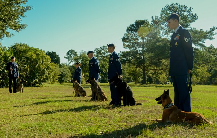 The 628th Security Forces Squadron Airmen hold a burial ceremony for military working dog Athos on Oct. 24, 2013, at Joint Base Charleston – Air Base, S.C. Athos was born Aug. 1998 and passed away Oct. 2012. Athos served as an explosive detector dog for 11 years. He was returned to JB Charleston where his ashes were buried alongside his fellow military working dogs. (U.S. Air Force photo/ Airman 1st Class Chacarra Neal)