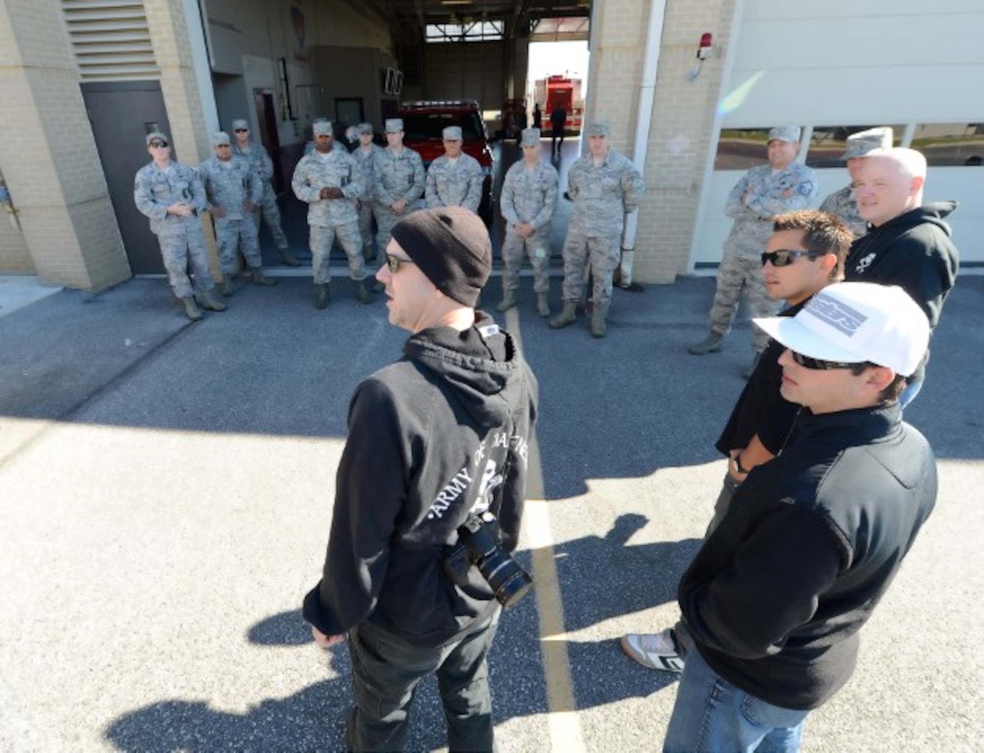 Sam Fleming, team leaders of the Army of Darkness motorcycle endurance racing team (center) answers questions from military riders gathered together at the base fire department during a visit to Dover Air Force Base, Del., on Oct. 21, 2013 to interact with Team Dover riders and discuss riding safely, teamwork and resiliency. The team has seven world championships and is a consistent points leader during races. (U.S. Air Force photo/Greg L. Davis) 