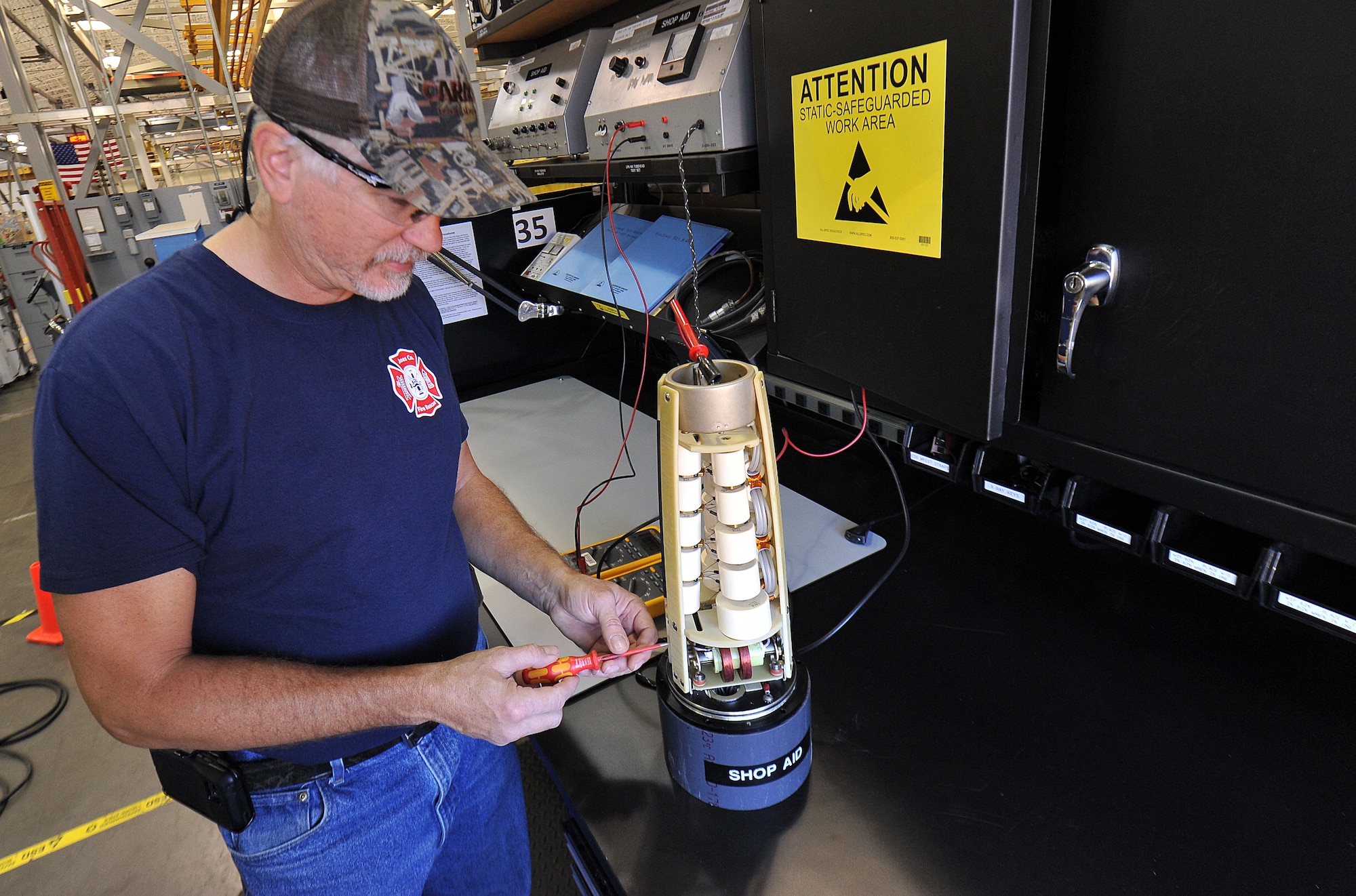 Karl Zimmer, 402nd Maintenance Support Group Electronic Industrial Control mechanic, measures the output of a high voltage assembly to be used in X-Ray equipment which will conduct testing inspections on vital assets. (U.S. Air Force photo by Tommie Horton)
