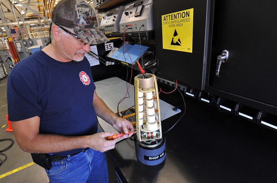 Karl Zimmer, 402nd Maintenance Support Group Electronic Industrial Control mechanic, measures the output of a high voltage assembly to be used in X-Ray equipment. This equipment will conduct testing inspections on vital assets. (U.S. Air Force photo/Tommie Horton) 
