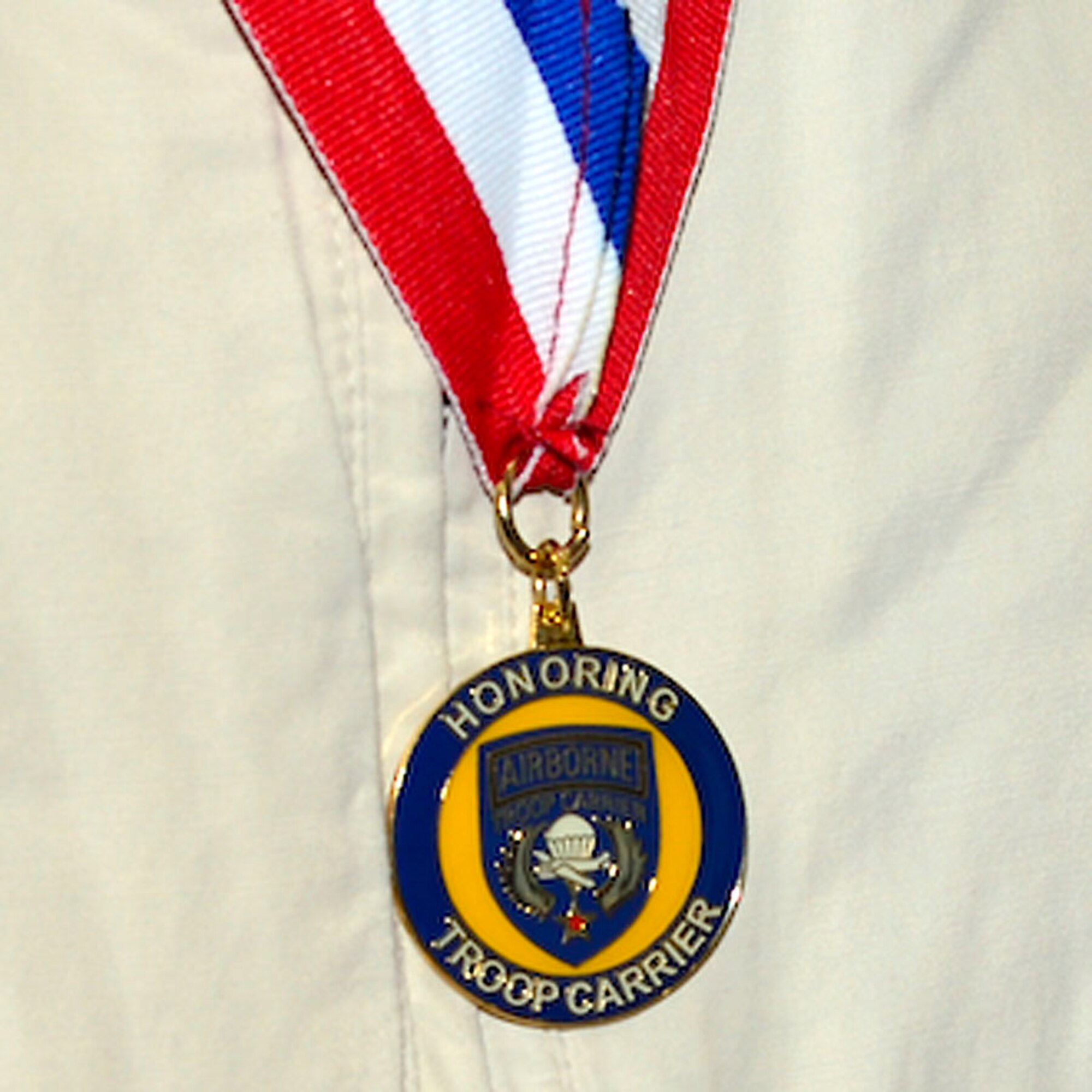 A medal that was presented to the World War II veterans from the 317th Troop Carrier Group sits on the neck of a recipient Oct. 18, 2013, at Dover Air Force Base, Del. Members of the 317th Troop Carrier Group were known as the “Jungle Skippers” who served in the Southwest Pacific Theater of Operations. (U.S. Air Force photo/David Tucker) 