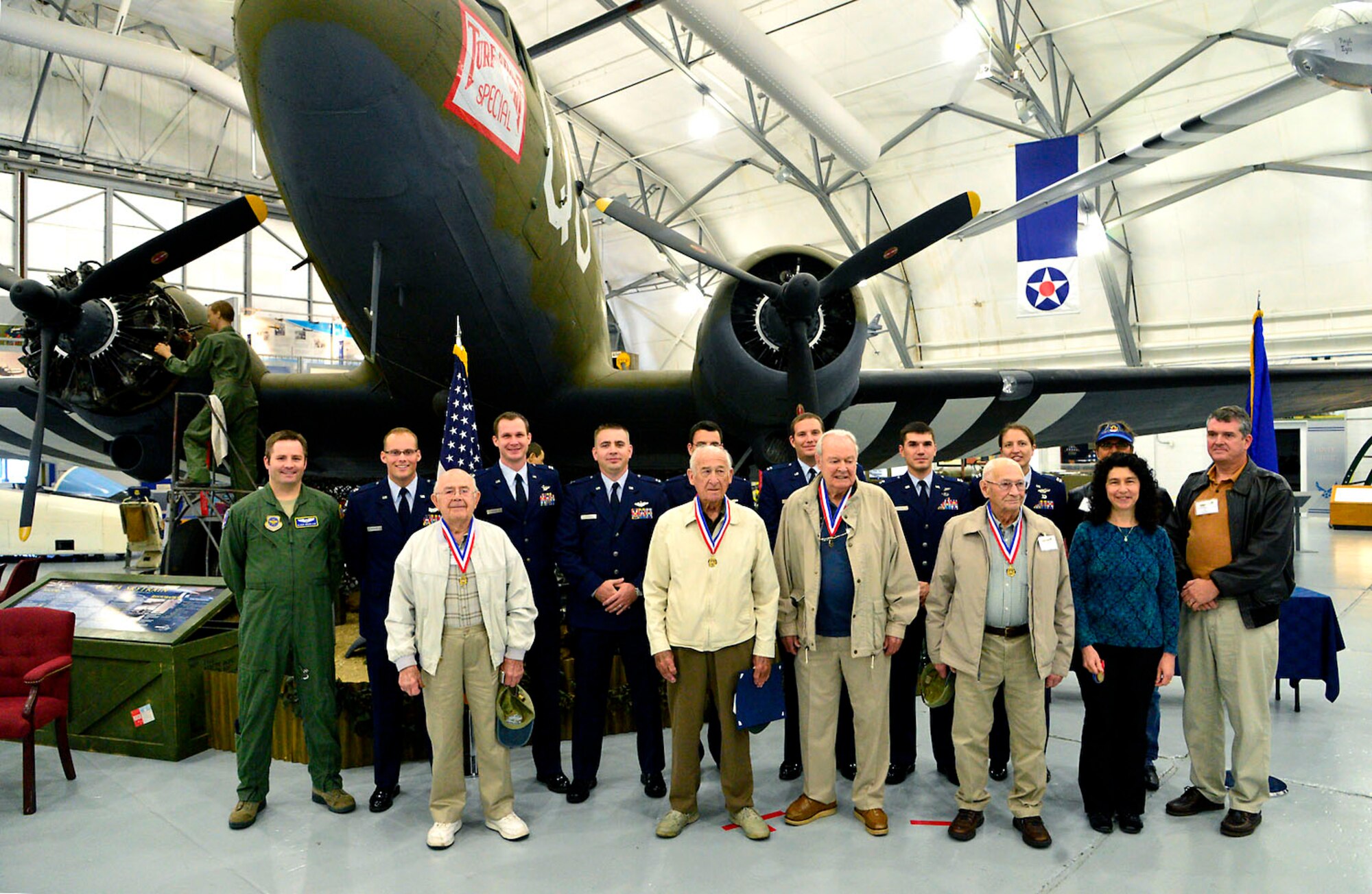 World War II veterans from the 317th Troop Carrier Group and pilots from the 436th Airlift Wing pose after a medal ceremony Oct. 18, 2013, at the Air Mobility Command Museum at Dover Air Force Base, Del. The 317th Troop Carrier Group was made up of the 39th, 40th, 41st and 46th Troop Carrier Squadrons. (U.S. Air Force photo/David Tucker)