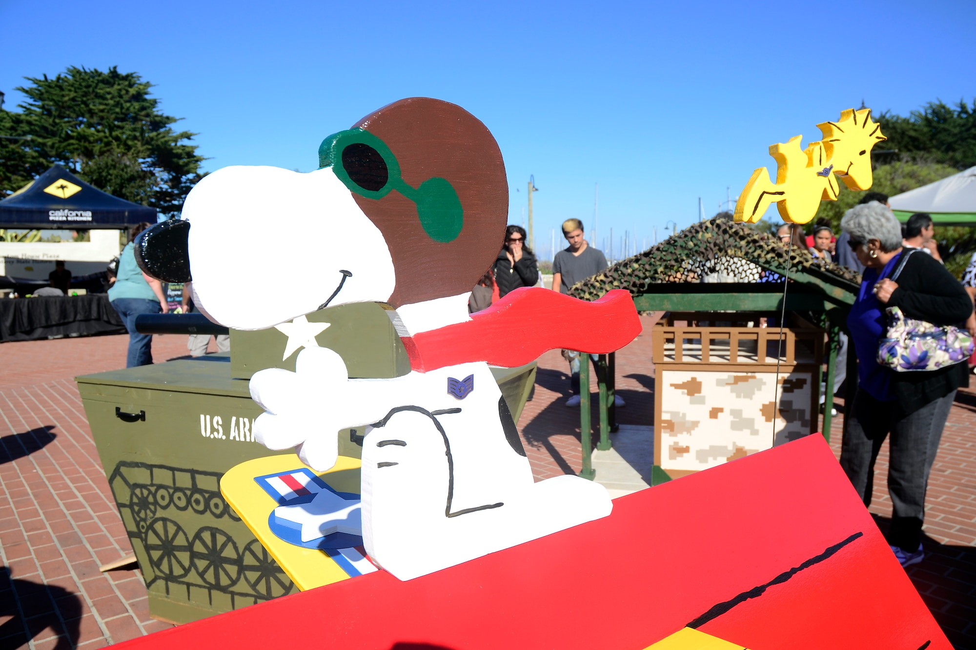 Snoopy sits atop his Air Force Sopwith Camel dog house, surrounded by the Army’s tank, Marine Corps “Semper Fido” and the Navy’s Lighthouse dog houses Oct. 13. The Air Force dog house, designed by the Defense Language Institute Foreign Language Center 517th Training Group, took home 1st prize in the fourth annual Monterey Dance for the Rescues, military services dog house competition, a local animal rescue charity event on the Monterey wharf. (Courtesy photo)


