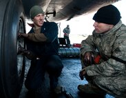 Senior Airman Cody Patterson, 28th Aircraft Maintenance Squadron crew chief, trains Airman 1st Class Oren Carr, 28th AMXS crew chief, on how to perform a brake replacement on a B-1 bomber at Ellsworth Air Force Base, S.D., Oct. 24, 2013. Ellsworth crew chiefs routinely check and maintain the brakes of all  B-1 bombers to ensure they are serviceable. (U.S. Air Force photo by Airman 1st Class Alystria Maurer/Released)
