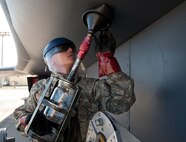 Airman 1st Class Peter Xiong, 28th Aircraft Maintenance Squadron crew chief, uses a sump draining tool to draw fuel from a fuel sump on a B-1 bomber at Ellsworth Air Force Base, S.D., Oct. 24, 2013. Crew chiefs perform this inspection to determine if there is debris or other contaminants in the fuel sump, items that could cause tremendous damage to the aircraft if not remedied. (U.S. Air Force photo by Airman 1st Class Alystria Maurer/Released)