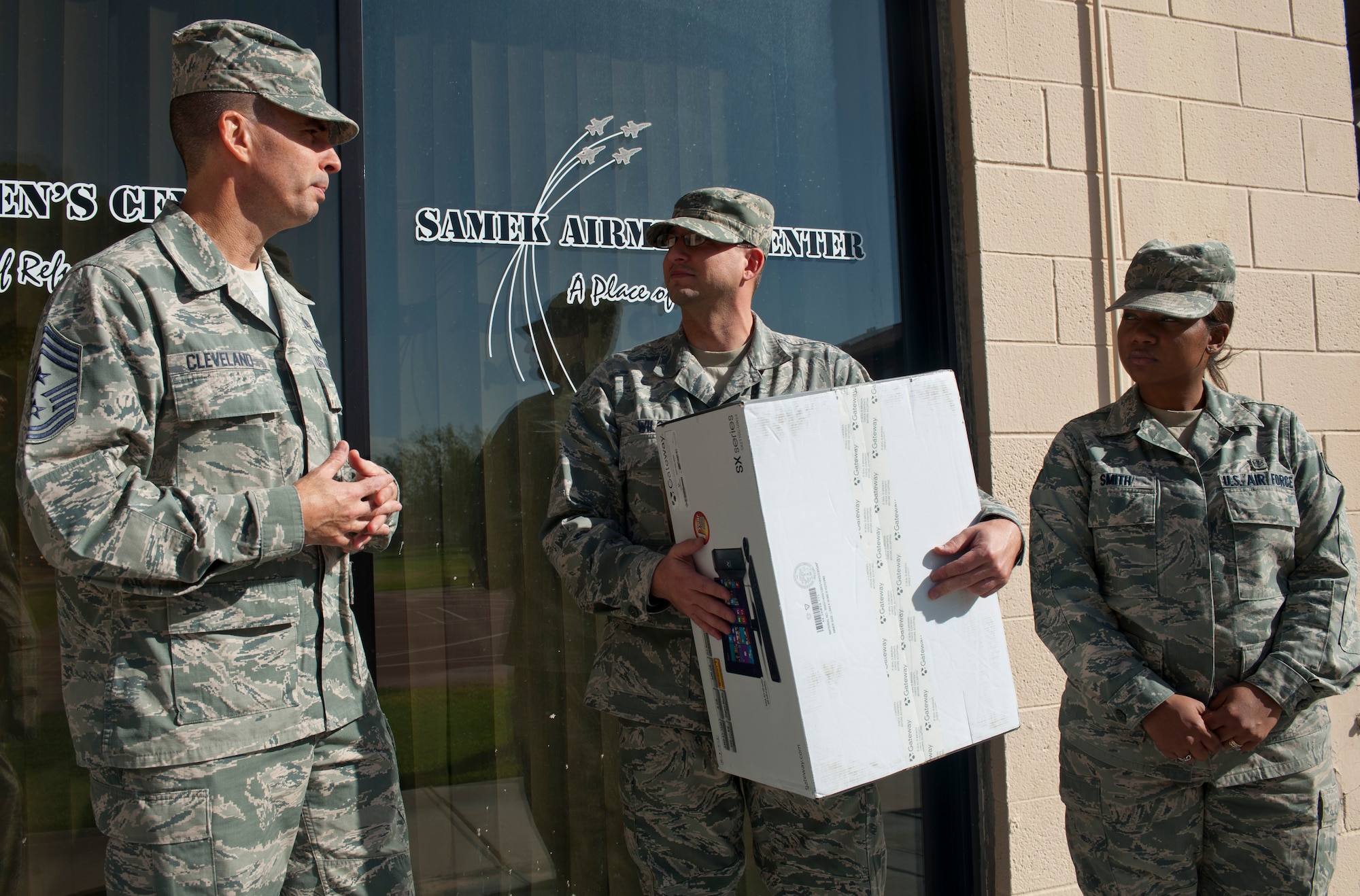 Chief Master Sgt. Steven Cleveland, 99th Air Base Wing command chief, presents a new computer to Master Sgt. Marcus Wilson, 99th Force Support Squadron Airman Against Drunk Driving council president, Oct. 28, 2013, at the Samek Airmen’s Center on Nellis Air Force Base, Nev. The new computer was donated to AADD from the Nellis Top 3 and 99th Command Chief’s office with help from the Nellis Support Team funds.  (U.S. Air Force photo by Staff Sgt. Michael Charles)