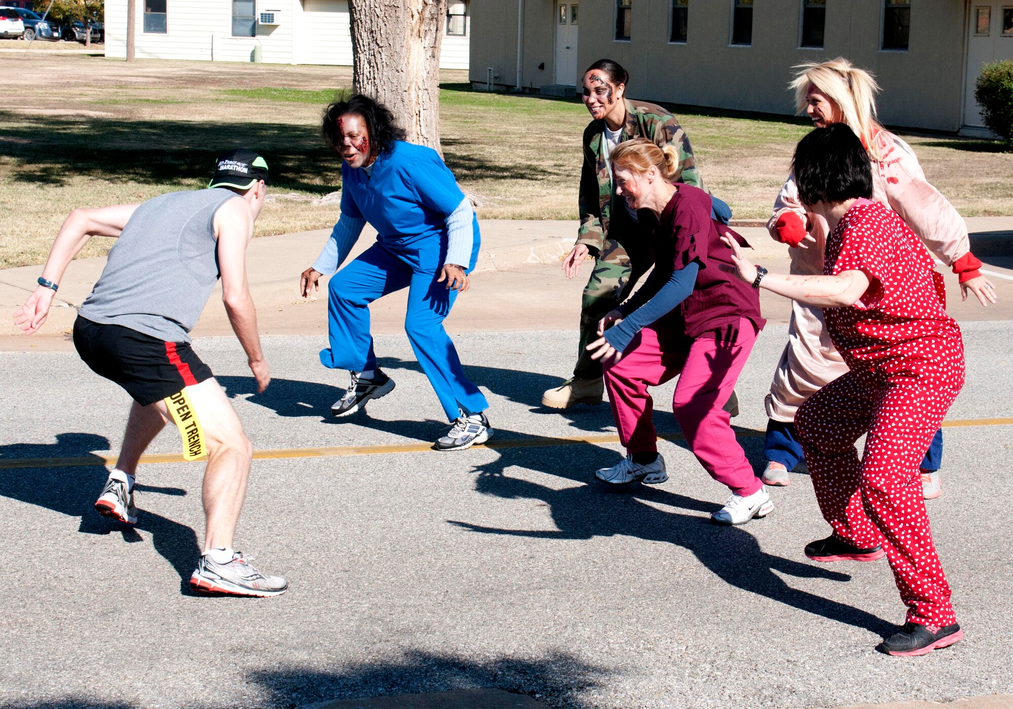 A runner tries to avoid the “undead” along the route of the 5K Zombie Fun Run held during Wingman Day, Oct. 24, at Vance Air Force Base, Okla. (U.S. Air Force photo/ Terry Wasson)