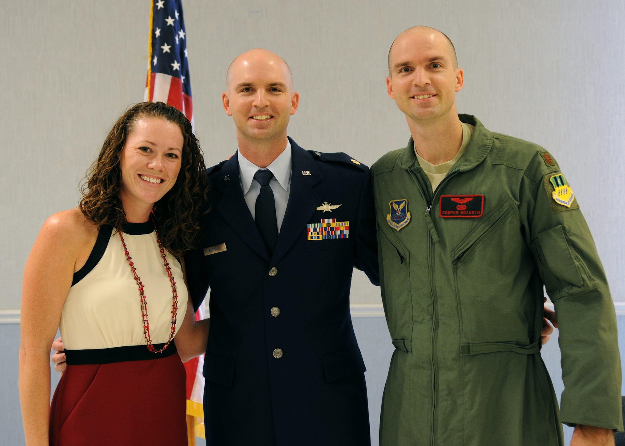Maj. Macey Bozarth (center), Air Force Global Strike Command force management branch chief, cyber officer functional manager and communications directorate, poses with his wife, Danielle, and his brother Maj. Cooper Bozarth, 96th Bomb Squadron radar navigator instructor, during his promotion on Barksdale Air Force Base, La., Sept. 30, 2012. Macey and Cooper entered the Air Force Academy in 1999 and were stationed at their first base together. (U.S. Air Force photo/Senior Airman Joseph Pagan)