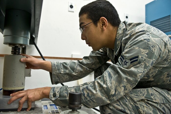 Airman 1st Class Michael Beaton, 57th Maintenance Squadron Precision Measurement Equipment Laboratory journeyman, aligns a force press onto a load cell Oct. 28, 2013, at the PMEL on Nellis Air Force Base, Nev. The load cell is an instrument used to properly calibrate a force press, which is used to measure the weight of scales and load cells for aircraft. (U.S. Air Force photo by Senior Airman Matthew Lancaster)
