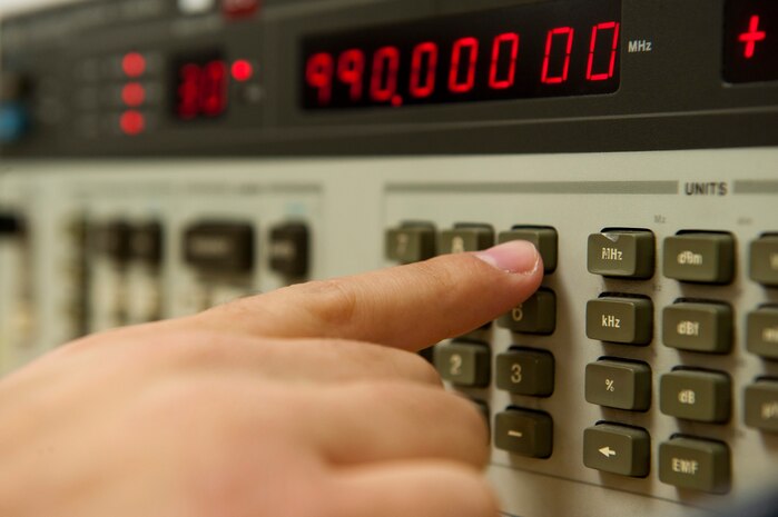 Staff Sgt. Christian Hubbard, 57th Maintenance Squadron Precision Measurement Equipment Laboratory craftsman, calibrates a low-frequency signal generator at the PMEL Oct. 28, 2013, at Nellis Air Force Base, Nev. The low-frequency signal generator is used to test various pieces of electronic equipment for its range. (U.S. Air Force photo by Airman 1st Class Thomas Spangler)