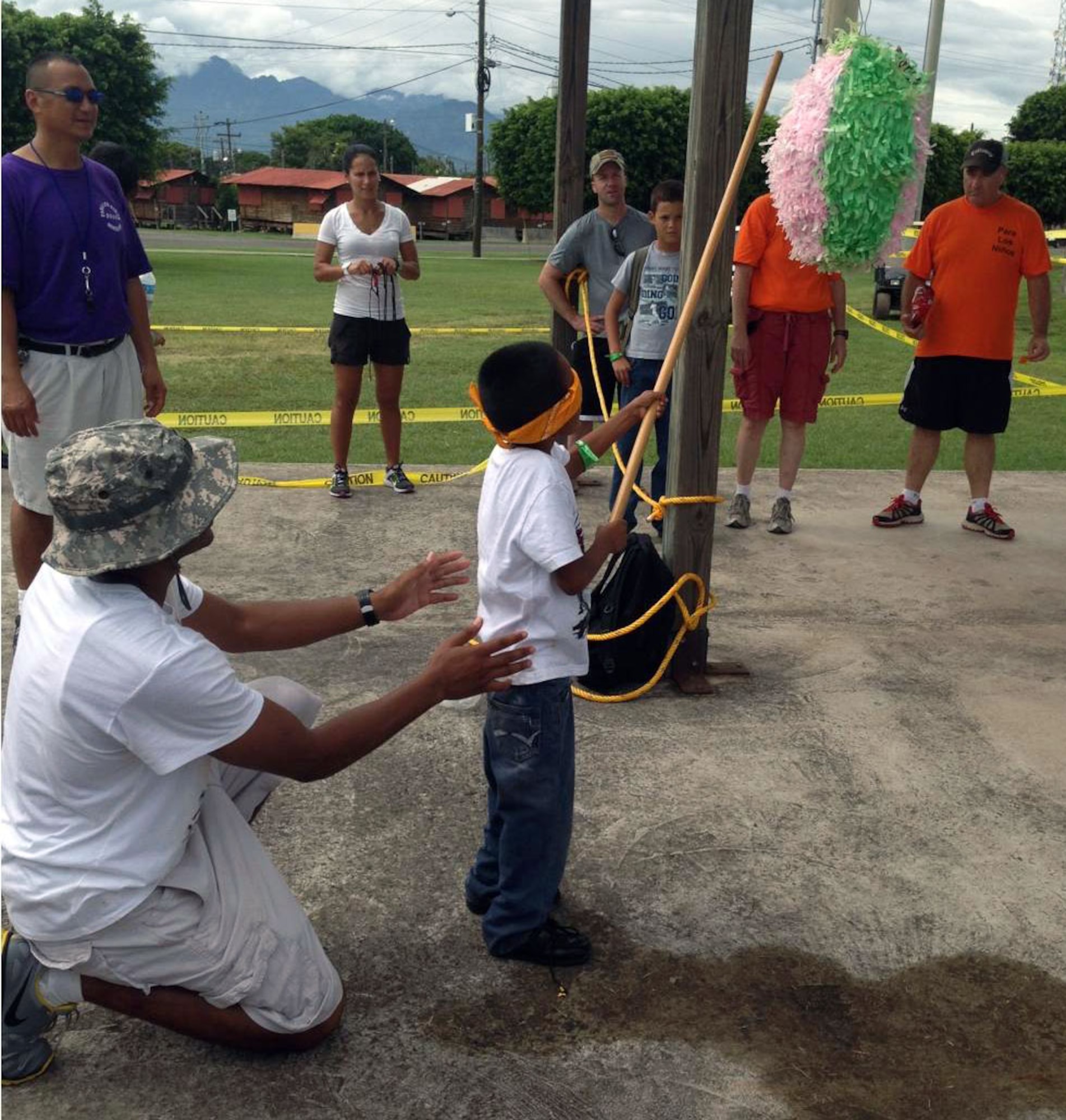 Members of Joint Task Force-Bravo's Medical Element (MEDEL) play with children from the Hogar Nazareth orphanage at Soto Cano Air Base, Honduras, Oct. 26, 2013.  MEDEL held a "Fiesta Day" for more than 60 children from the orphanage.  (Photo by U.S. Army Spc. Andrea Howard )