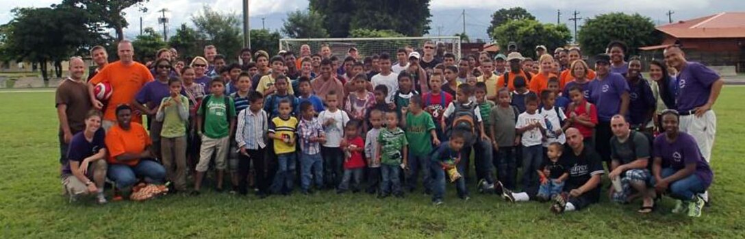 Members of Joint Task Force-Bravo's Medical Element (MEDEL) pose with children from the Hogar Nazareth orphanage at Soto Cano Air Base, Honduras, Oct. 26, 2013.  MEDEL held a "Fiesta Day" for more than 60 children from the orphanage.  (Photo by U.S. Army Sgt. Jennifer Shick)