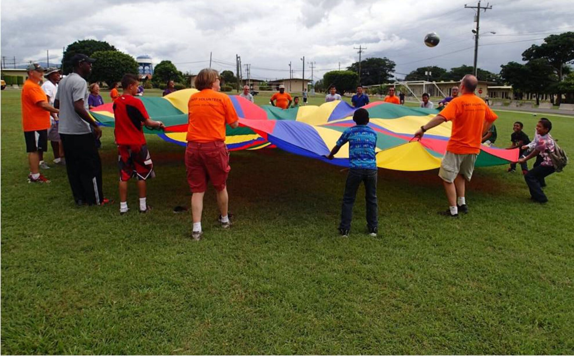 Members of Joint Task Force-Bravo's Medical Element (MEDEL) play games with children from the Hogar Nazareth orphanage at Soto Cano Air Base, Honduras, Oct. 26, 2013.  MEDEL held a "Fiesta Day" for more than 60 children from the orphanage.  (Photo by U.S. Army Sgt. Jennifer Shick)