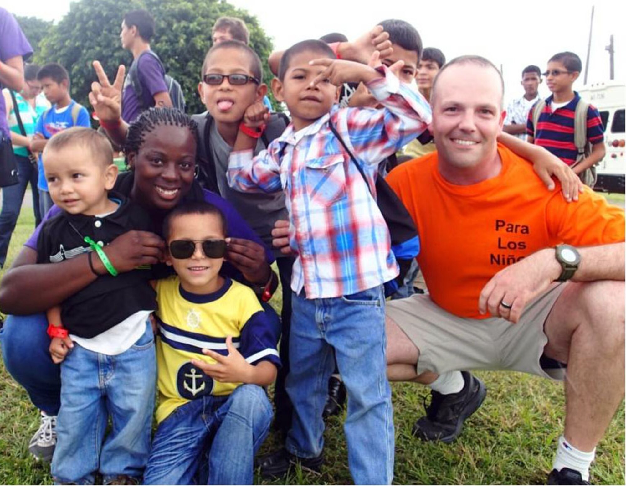 Members of Joint Task Force-Bravo's Medical Element (MEDEL) pose with children from the Hogar Nazareth orphanage at Soto Cano Air Base, Honduras, Oct. 26, 2013.  MEDEL held a "Fiesta Day" for more than 60 children from the orphanage.  (Photo by U.S. Army Sgt. Jennifer Shick)