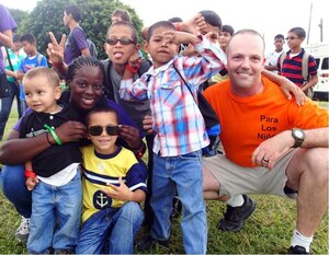 Members of Joint Task Force-Bravo's Medical Element (MEDEL) pose with children from the Hogar Nazareth orphanage at Soto Cano Air Base, Honduras, Oct. 26, 2013.  MEDEL held a "Fiesta Day" for more than 60 children from the orphanage.  (Photo by U.S. Army Sgt. Jennifer Shick)