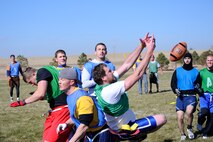 Players from the 2nd Space Operations Squadron (blue) and U.S. Air Force Warfare Center (green) fight for the ball in one of the final plays of a Schriever intramural flag fooball semifinal game here Oct. 29.  The pass fell incomplete and 2 SOPS held on for a 19-13 victory.  In the day's other semifinal, 4th Space Operations Squadron beat 3rd Space Operations Squadron 20-6. The winners will match up in the championship game Friday at 11 a.m. (U.S. Air Force photo/Christopher DeWitt)