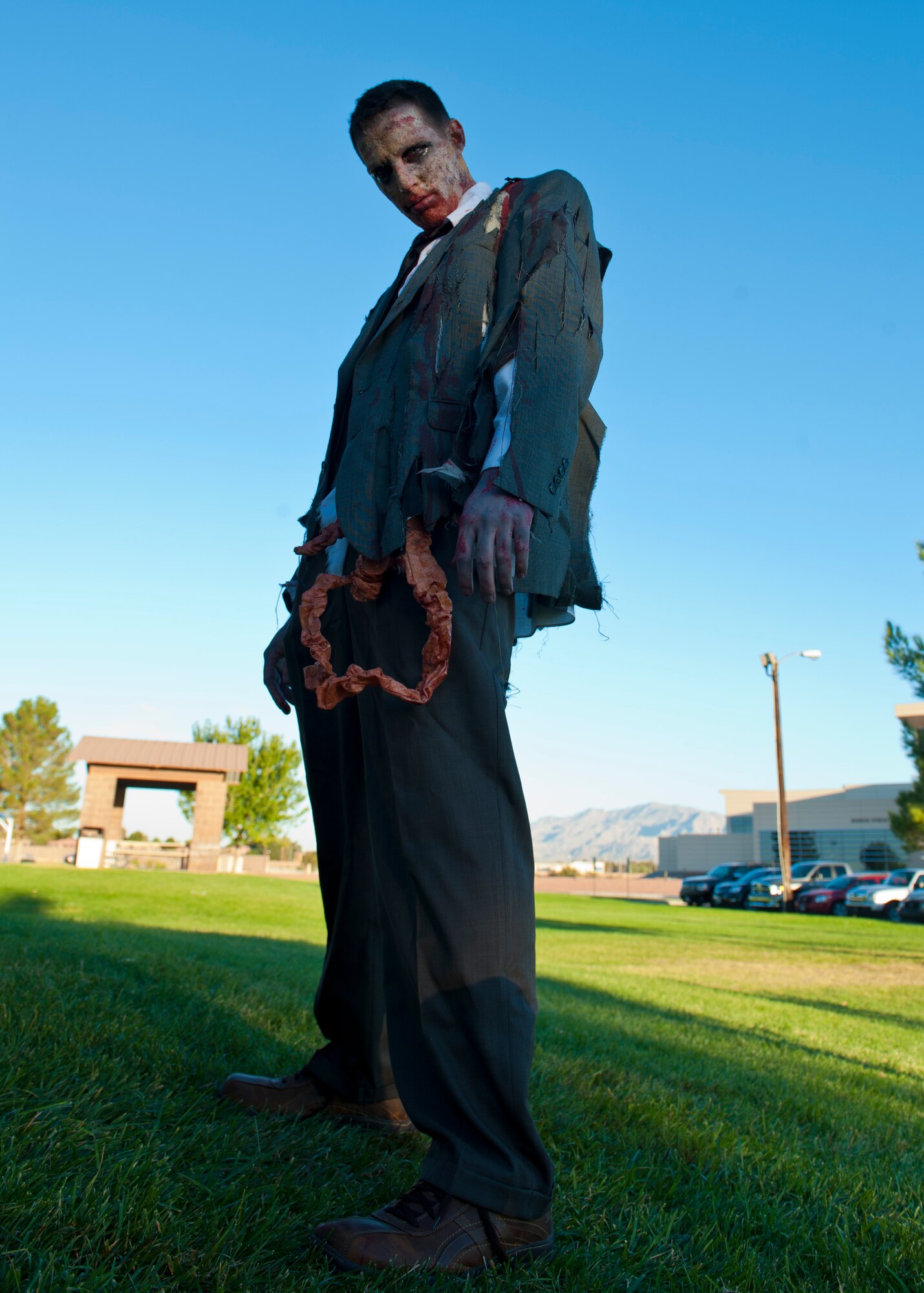 An Airman from Creech Air Force Base dons a full zombie costume at Freedom Park Oct. 26, 2013, at Nellis Air Force Base, Nev. Airmen from Nellis and Creech AFBs ran from simulated zombies during a 5-kilometer run to celebrate Halloween. (U.S. Air Force photo by Airman 1st Class Thomas Spangler)