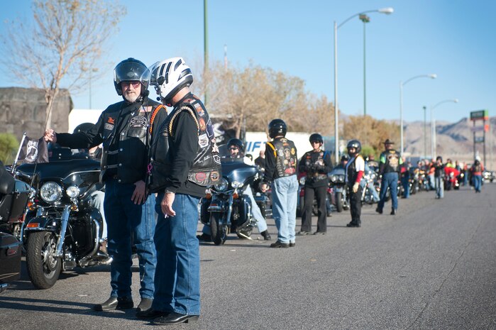 Dave Jones (left) and Rod Heriford, both members of The Nation of Patriots, prepare to line up and move an American Flag to Nellis Air Force Base, Nev., during The Patriot Tour Oct. 26, 2013, in Las Vegas. The Nation of Patriots passes an American Flag throughout the country to honor and pay tribute to all past, present and fallen service members of America's armed forces every year. (U.S. Air Force photo by Staff Sgt. Christopher Hubenthal)