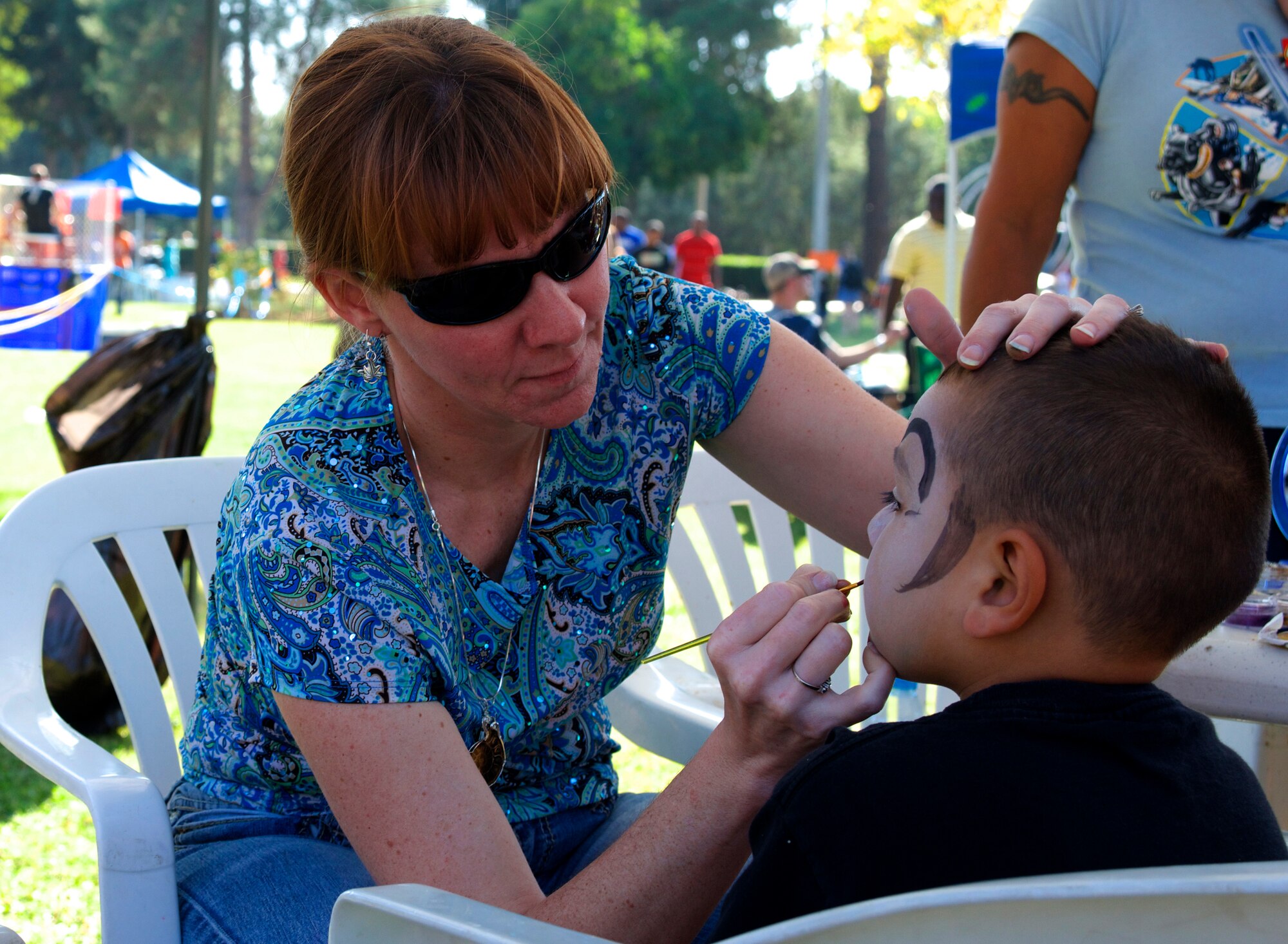 Senior Master Sgt. Angela Stout, 39th Comptoller Squadron superintendent, paints on a youth’s face during Fall Fest Oct. 26, 2013, at Incirlik Air Base, Turkey. Each year, the 39th Force Support Squadron hosts Fall Fest to celebrate the new season while bringing a fair-like atmosphere to Incirlik. (U.S. Air Force photo by Staff Sgt. Eric Summers Jr./Released)