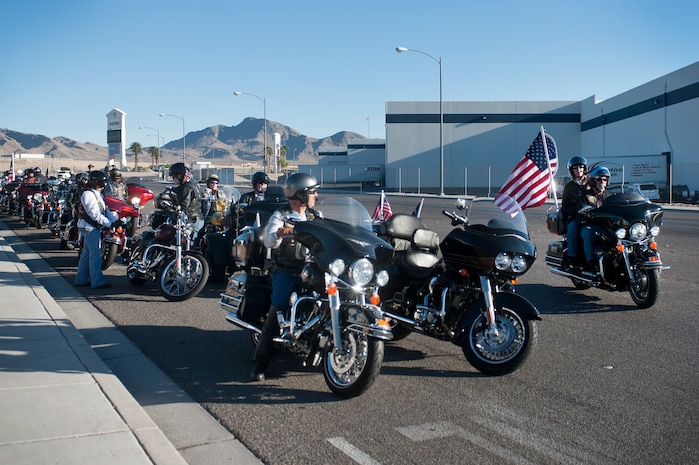 Members of The Nation of Patriots line up and prepare to move an American Flag to Nellis Air Force Base, Nev., during The Patriot Tour Oct. 26, 2013, in Las Vegas. The Nation of Patriots passes an American Flag throughout the country to honor and pay tribute to all past, present and fallen service members of America's armed forces every year. (U.S. Air Force photo by Staff Sgt. Christopher Hubenthal)