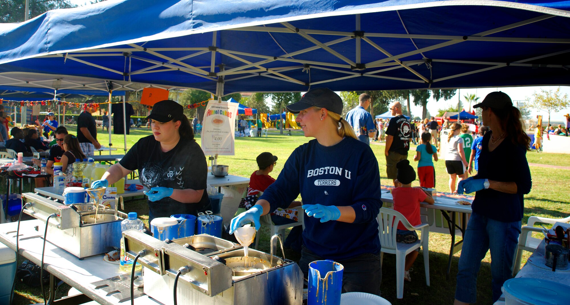 Members of the Incirlik Combined Spouses Club make funnel cakes during the 2013 Fall Fest Oct. 26, 2013, at Incirlik Air Base, Turkey. Members of various private organizations set up different booths and competitions to include a noncombatant evacuation operations awareness table. (U.S. Air Force photo by Staff Sgt. Eric Summers Jr./Released)