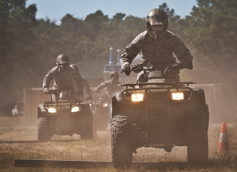 Staff Sgt. Zachaeus Zebrowski, of the 96th Ground Combat Training Squadron, leads riders across wooden planks during an ATV training class Oct. 25 at Eglin Air Force Base, Fla.  Approximately 20 Airmen from the 96th Security Forces Squadron and the 96th Ground Combat Training Squadron received the training over two days.  The new riders learned riding fundamentals and even some complicated techniques during the four-hour course. (U.S. Air Force photo/Samuel King Jr.)