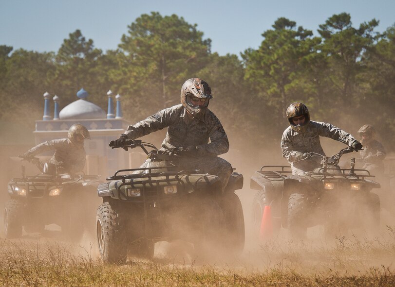 Staff Sgt. Ryan Quick, of the 96th Ground Combat Training Squadron, leads a group of riders through a series of cones during an ATV training class Oct. 25 at Eglin Air Force Base, Fla.  Approximately 20 Airmen from the 96th Security Forces Squadron and the 96th Ground Combat Training Squadron received the training over two days.  The new riders learned riding fundamentals and even some complicated techniques during the four-hour course. (U.S. Air Force photo/Samuel King Jr.)