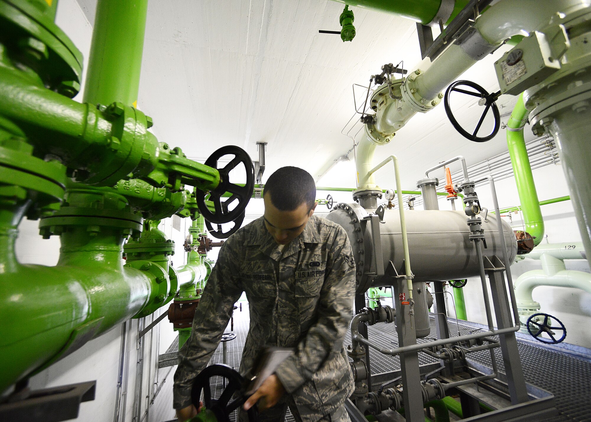 Airman 1st Class Devin Brown-Redfearn, 31st Logistics Readiness Squadron fuels facility journeyman, turns a wheel while checking pressure in the cryogenics facility, Oct. 16, 2013, at Aviano Air Base, Italy. The fuels facilities section manages 10 storage tanks, holding between 600,000 and 1.3 million gallons of Jet Propellant-8 fuel, which flows to multiple hard-top refueling stations on the flightline. (U.S. Air Force photo/Airman Ryan Conroy) 