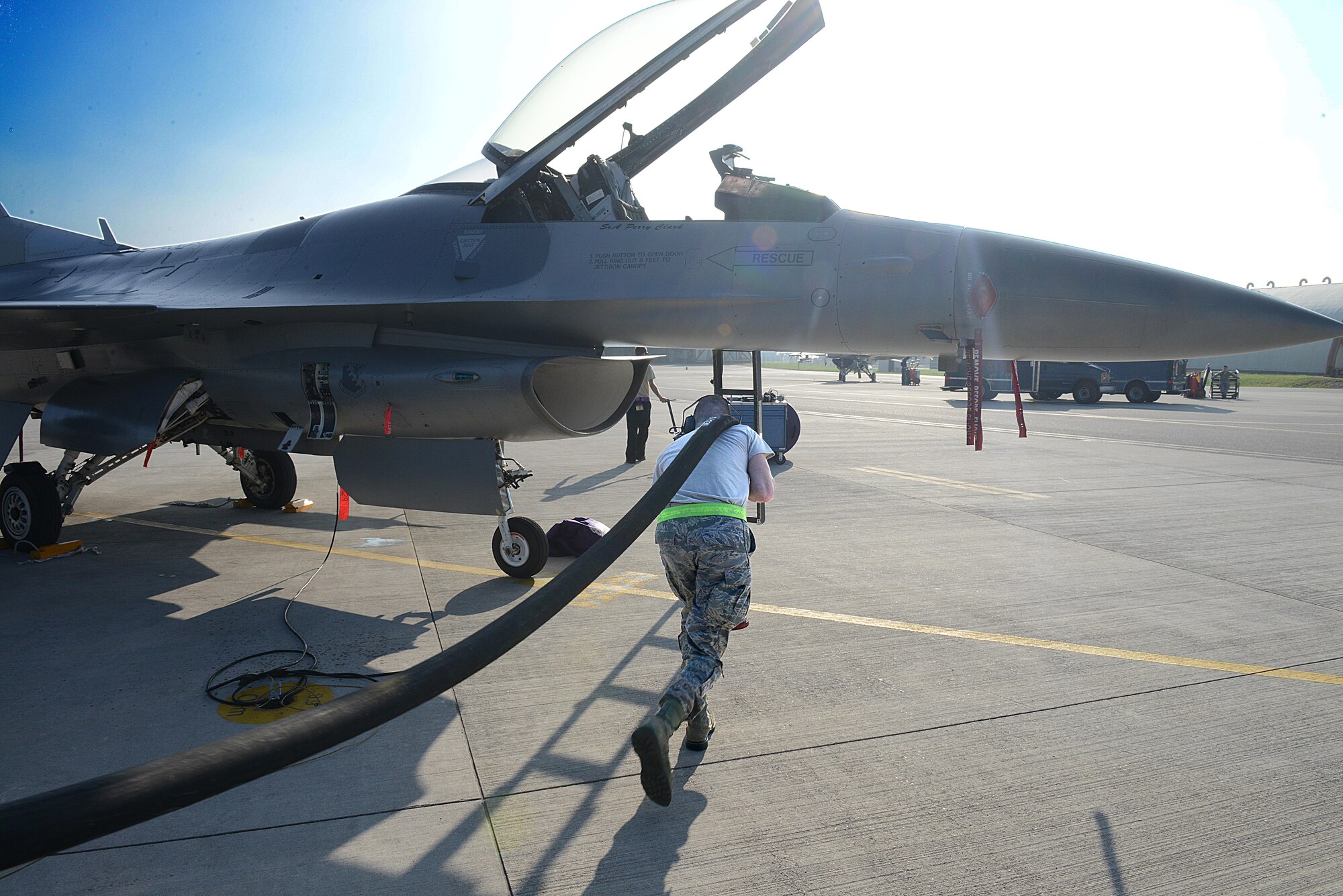 Airman 1st Class Nelson Crane, 31st Logistics Readiness Squadron fuels distribution journeyman, pulls a hose from an R-11 refueling truck towards an F-16 Fighting Falcon, Oct. 16, 2013, at Aviano Air Base, Italy. The 31st LRS fuels management flight distributes more than 9 million gallons of fuel per year. (U.S. Air Force photo/Airman Ryan Conroy) 