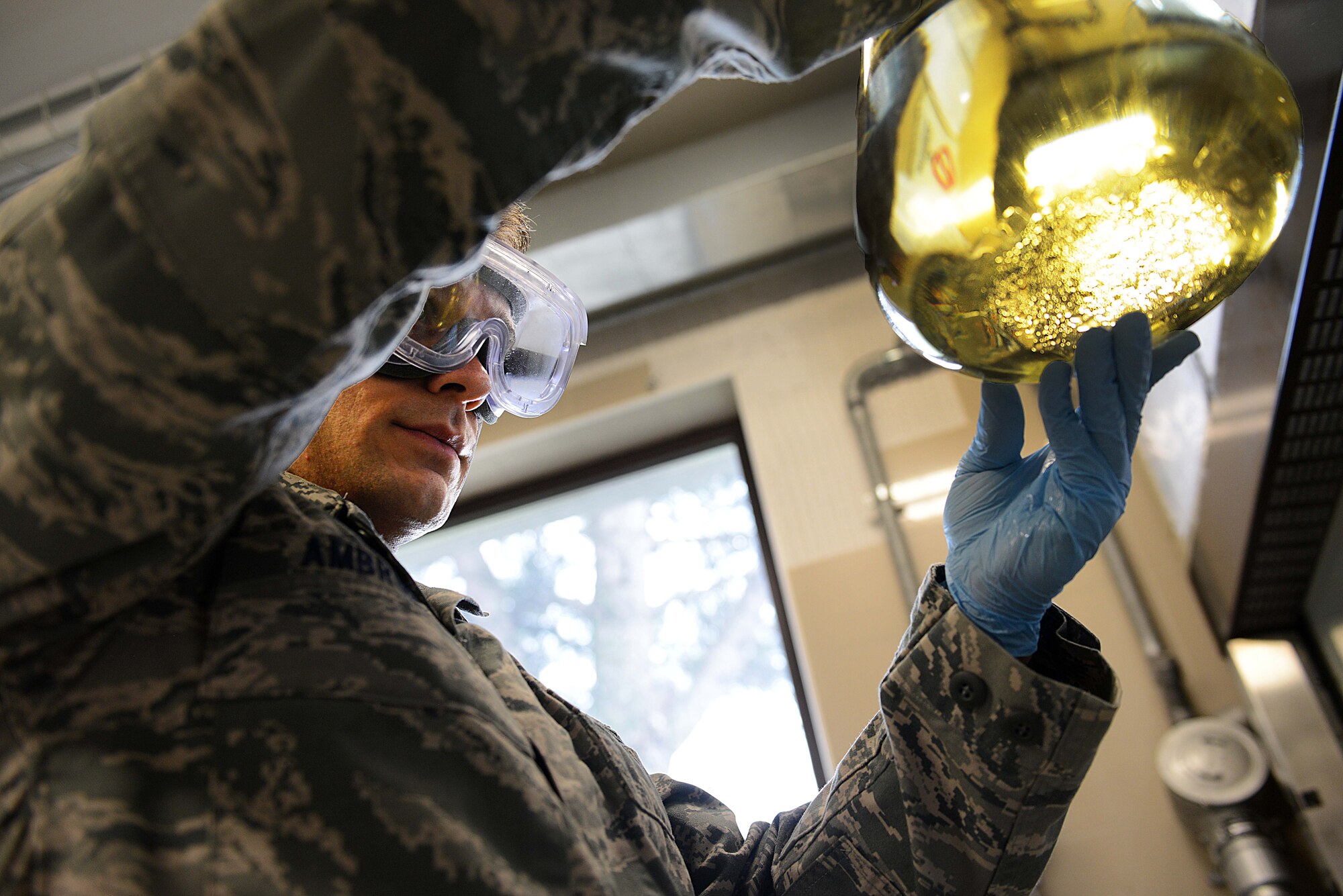 Staff Sgt. David Ambrusko, 31st Logistics Readiness Squadron fuels lab NCO in charge, inspects a beaker full of jet fuel for water, Oct. 16, 2013, at Aviano Air Base, Italy. The fuels laboratory ensures the quality of incoming fuel from an outside source by running it through a series of tests to include checking for water, which can cause engine malfunctions at high altitudes. (U.S. Air Force photo/Airman Ryan Conroy)   