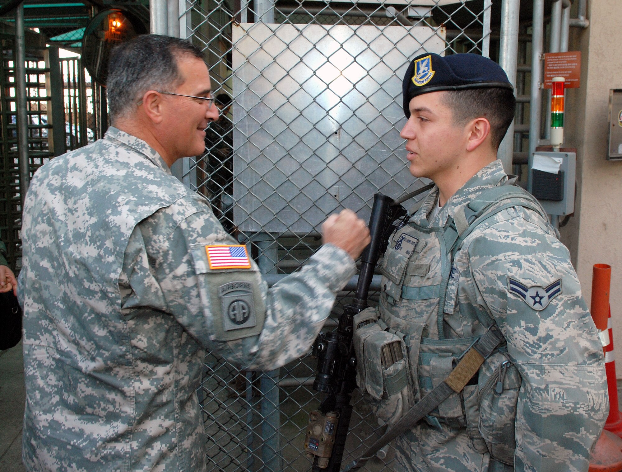 OSAN AIR BASE, Republic of Korea - Army Gen. Curtis Scaparrotti, commander of United Nations Command, Combined Forces Command and U.S. Forces Korea, gives Airman 1st Class Alejandro Cantu's body armor a friendly thump before entering the Korea Air Operations Center  as part of a familiarization visit to 7th Air Force and Osan Air Base Oct. 30. Cantu, a 51st Security Forces Squadron member from Del Rio, Texas, was quizzed by the general on his mission as a sentry for the Korea Air Operations Center, and Cantu recited for him his post briefing. (U.S. Air Force photo by Tech. Sgt. Thomas J. Doscher)