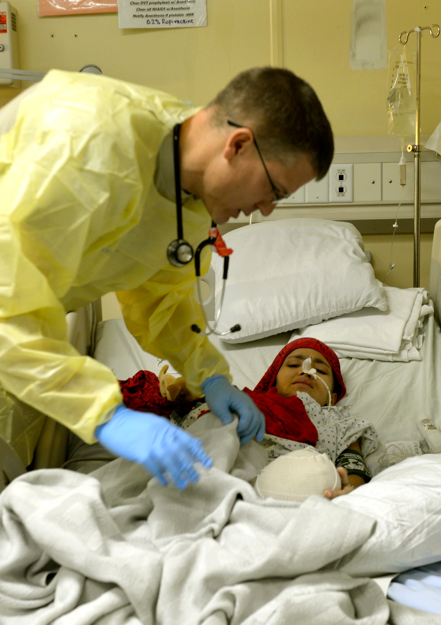 Lt. Col. David Jones, 455th Expeditionary Medical Group pediatrician, examines a 12-year-old girl’s leg in the Craig Joint Theater Hospital on Bagram Airfield, Afghanistan, Oct. 20. The girl’s leg was recently amputated because of a malignant tumor. (U.S. Air Force photo/ Staff Sgt. Stephenie Wade)