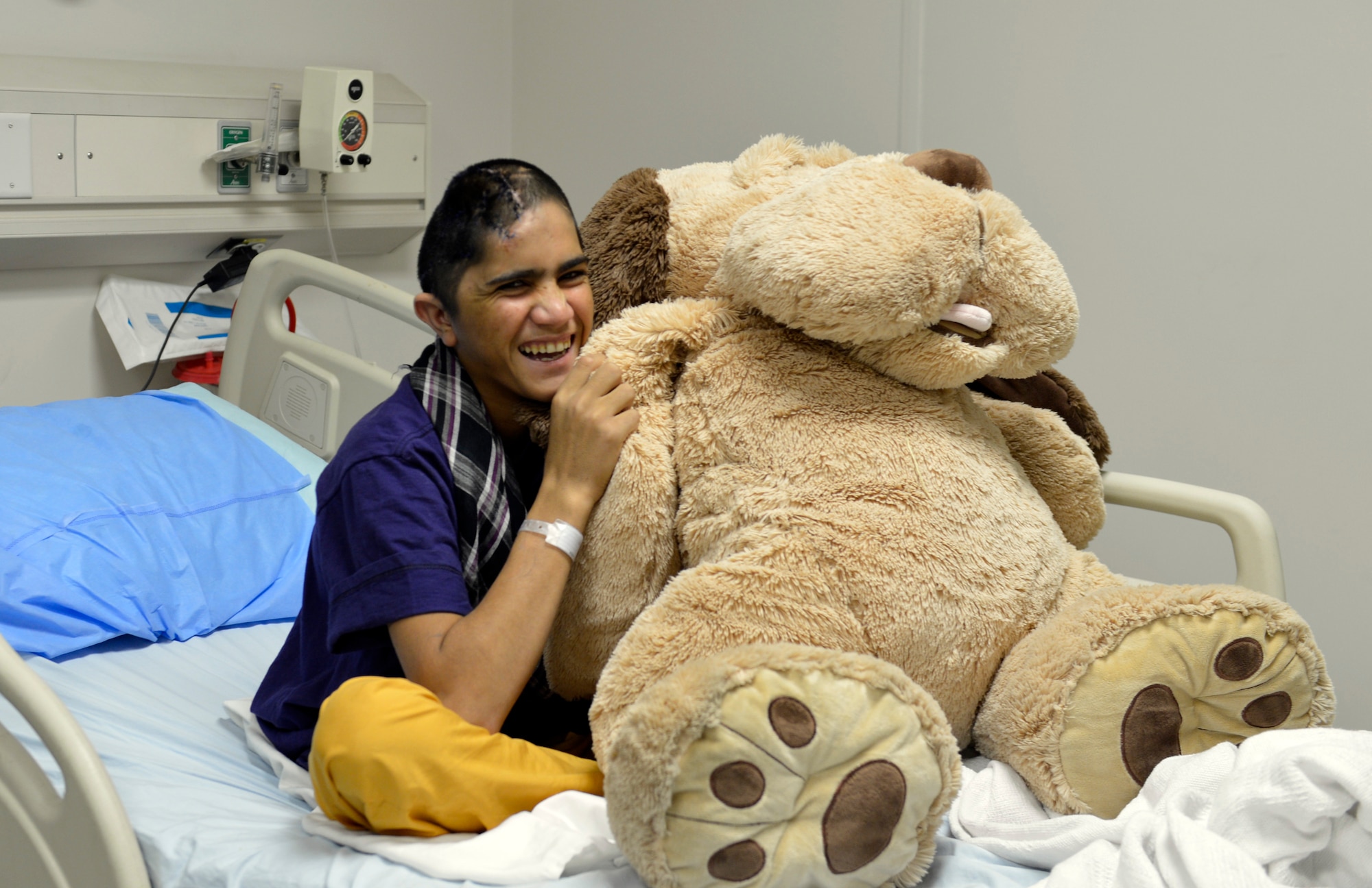 A 12-year-old boy sits in his hospital bed with a stuffed animal in the Craig Joint Theater Hospital on Bagram Airfield, Afghanistan, Oct. 20. The boy recently had a surgery to help release pressure on his brain and is being treated for an infection. Prior to coming in he could barely walk or talk and now he is smiling. Jones is a native of San Antonio, Texas.  (U.S. Air Force photo/ Staff Sgt. Stephenie Wade)