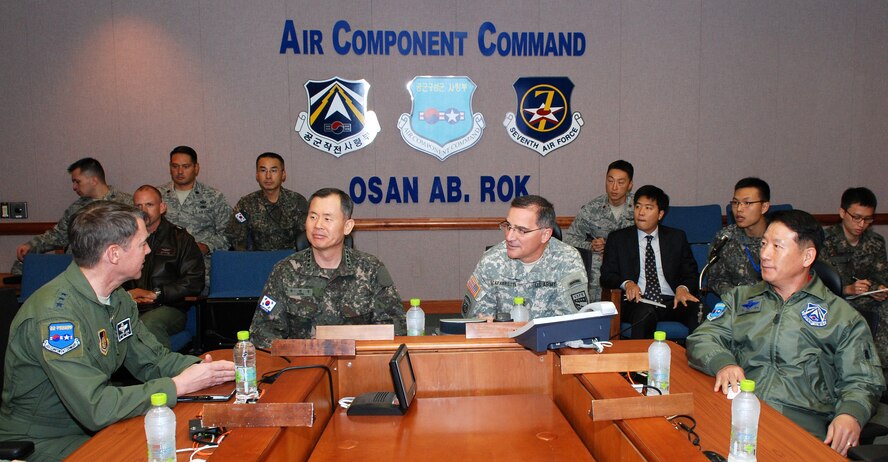 OSAN AIR BASE, Republic of Korea - (From left to right) Air Force Lt. Gen. Jan-Marc Jouas, 7th Air Force commander; Republic of Korea Gen. Park, Seon Woo, Combined Forces Command deputy commander;  Army Gen. Curtis Scaparrotti, commander of United Nations Command, Combined Forces Command and U.S. Forces Korea; and Republic of Korea Lt. Gen. Choi, Cha-Kyu, ROK Air Force Operations Command commander sits down to a 607th Air and Space Operations Center familiarization briefing during a visit to 7th Air Force and Osan Air Base Oct. 30. USFK and CFC leadership flew to Osan to learn more about how the air power team of 7 AF operates during peace and wartime. During the visit, Scaparrotti and Park got a closer look at how the 607th AOC functions day-to-day. (U.S. Air Force photo by Tech. Sgt. Thomas J. Doscher)