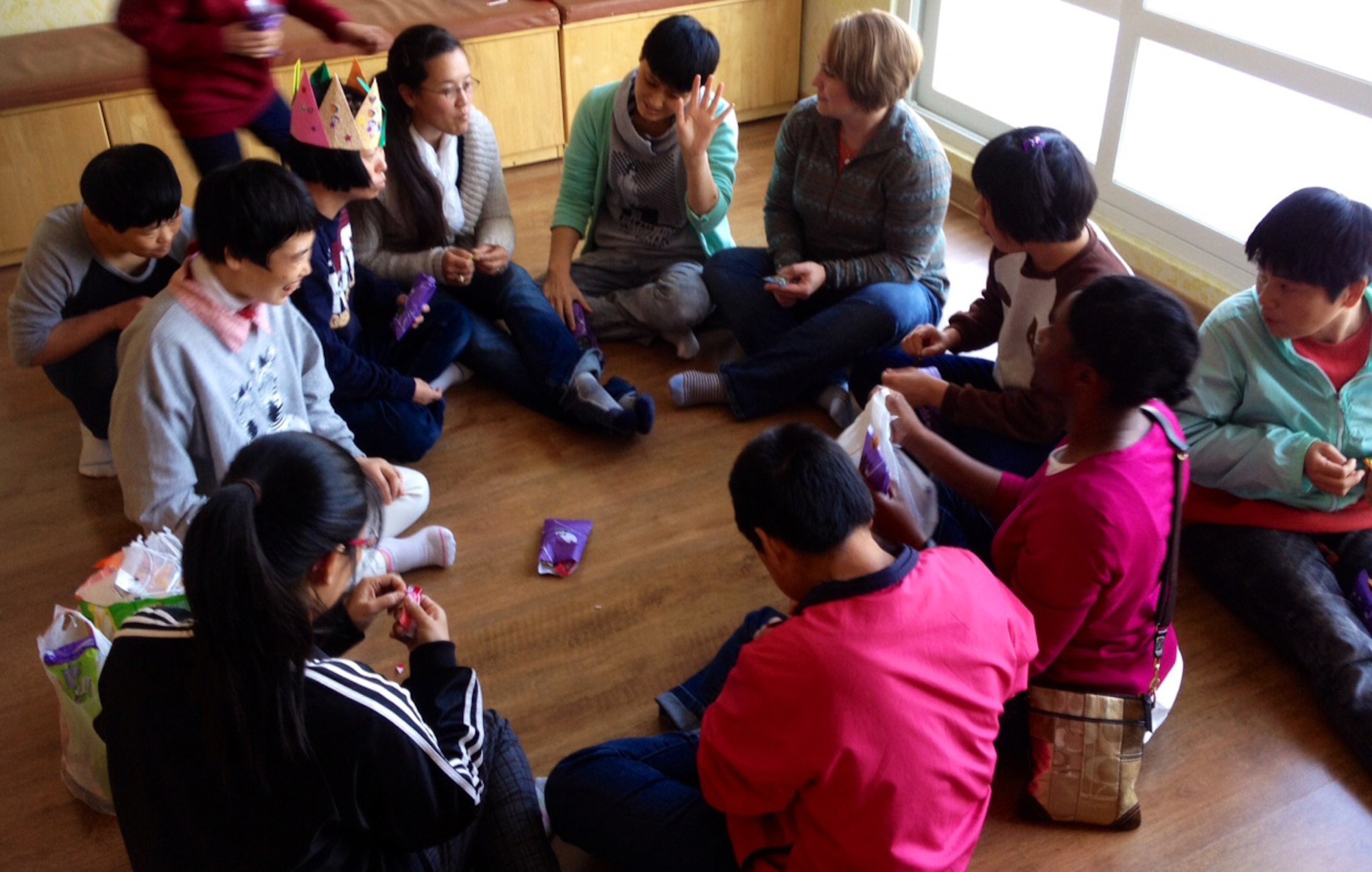 Volunteers talk to residents of the Seongsimdongwon Group Home for the disabled in Osan City, Republic of Korea, Oct. 27, 2013. Employees had the chance to enjoy time off while volunteers served lunch to more than 120 residents and students with special needs. (U.S. Air Force photo/Capt. Tamara Fischer-Carter)