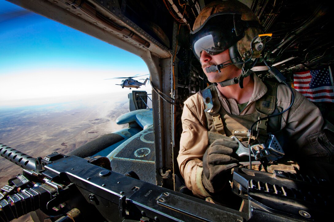 U.S. Marine Corps Lance Cpl. Andrew J. Savoie provides aerial security over Helmand province, Afghanistan, Oct. 28, 2013. Marine Heavy Helicopter Squadron 462 supported Bravo Company, 1st Battalion, 9th Marine Regiment, during an interdiction operation in Gurjat village. Savoie, a crew chief, is assigned to the squadron.