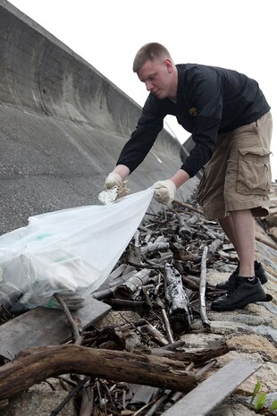 on facebookShare on twitterShare on emailShare on printMore Sharing Services0Volunteer Chad A. Welsh fills his trash bag with pieces of an old foam buoy after searching through piles of driftwood at the seawall north of Penny Lake aboard Marine Corps Air Station Iwakuni April 20, 2012. The cleanup is an annual event that takes place every Earth Day.