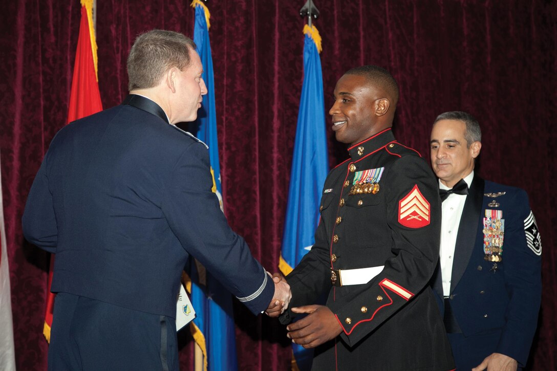 Sgt. Ricardo S. Scales, right, receives his diploma from Brig. Gen. James B. Hecker during the Airman Leadership School graduation Oct. 25 at the Rocker NCO Club on Kadena Air Base. Scales was one of two Marines to attend the ALS for the first time in six years. Scales is an air support operations operator with Marine Aircraft Support Squadron 2, Marine Aircraft Group 36, 1st Marine Aircraft Wing, III Marine Expeditionary Force. Hecker is the commanding general of the 18th Wing. (U.S. Marine Corps photo by Lance Cpl. Natalie M. Rostran/Released)