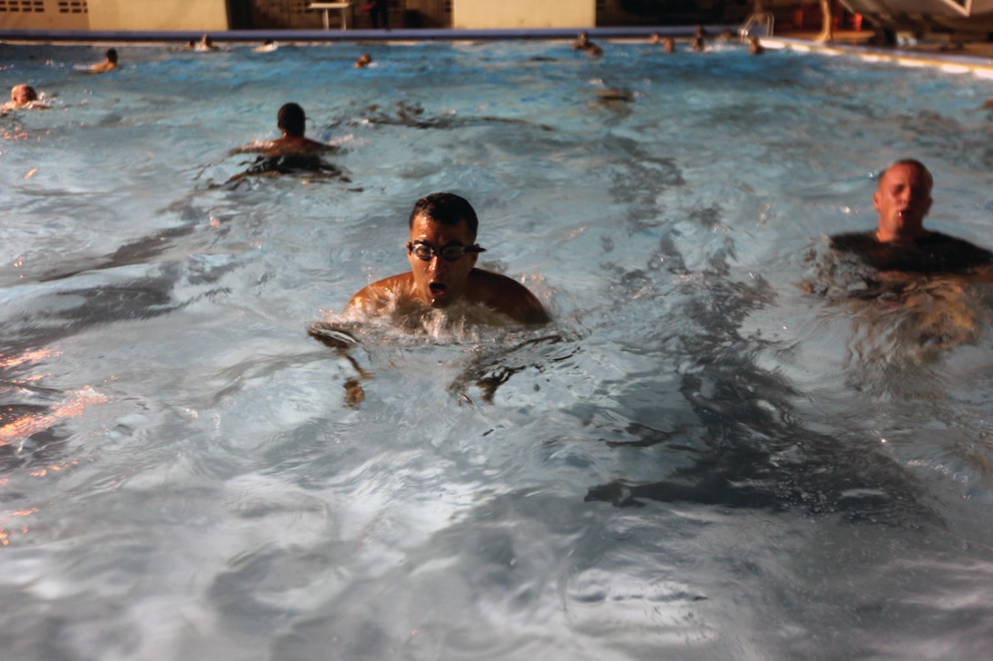 Maj. Rigoberto G. Colon, center, attempts to swim 500-meters in 12 minutes and 30 seconds during a reconnaissance physical assessment test at Camp Hansen Oct. 24. Every Marine in 3rd Reconnaissance Battalion is expected to participate in the RPAT, according to Lt. Col. Eric N. Thompson, the commanding officer of 3rd Recon. Bn., 3rd Marine Division, III Marine Expeditionary Force. Colon is the executive officer for the battalion. (U.S. Marine Corps photo by Lance Cpl. Matthew S. Myers/Released)