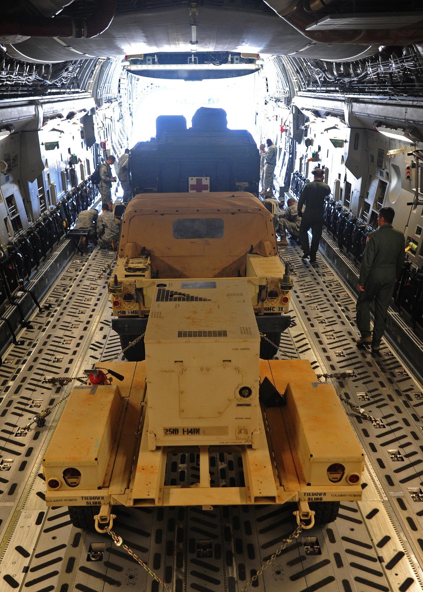 Army 1st Battalion, 14th Infantry Soldiers assigned to the 2nd Stryker Brigade Combat Team load a Stryker Medical Evacuation Vehicle aboard a C-17 Globemaster III during a validation exercise with the help of 535th Airlift Squadron loadmasters on the flightline at Joint Base Pearl Harbor Hickam, Hawaii, Oct. 17, 2013. 