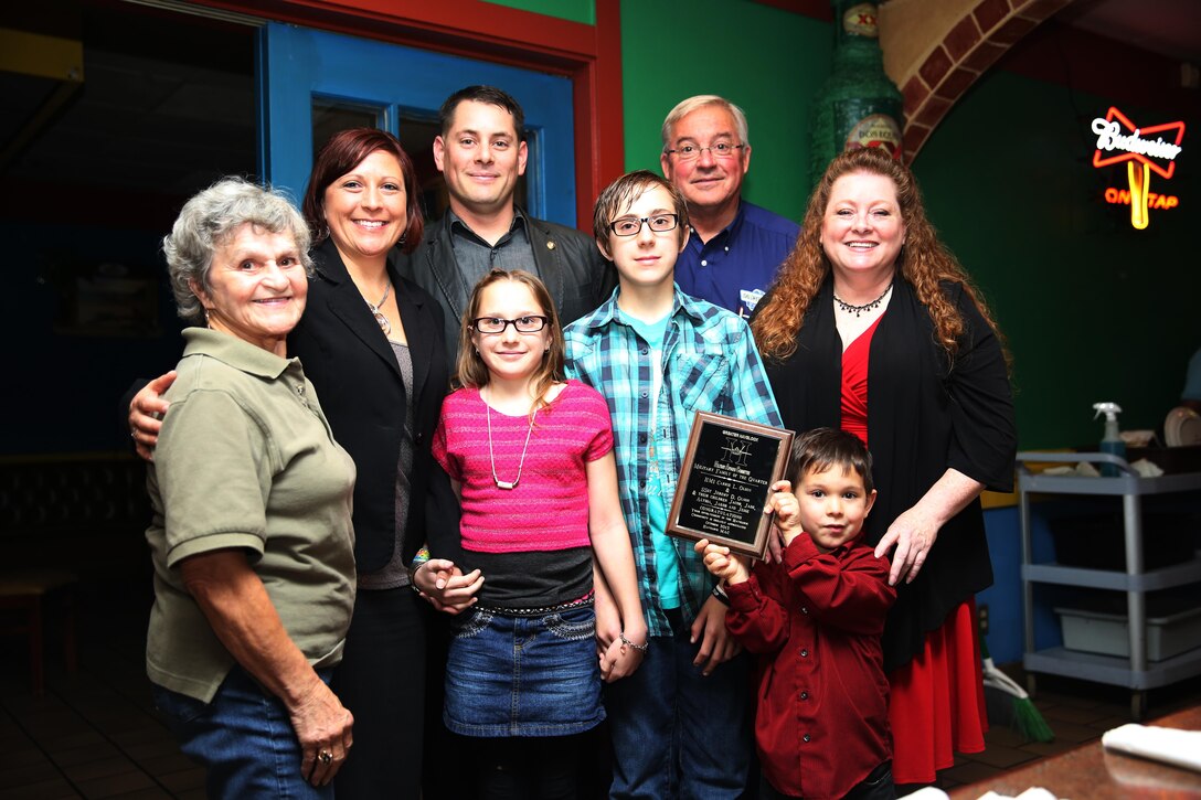 Petty Officer First Class Carie L. Olson, her family and members of Havelock's Military Affairs Committee come together after Olson and her family were named Service Family of the Quarter Oct. 22 at El Cerro Mexican Bar and Grill. Olson and her family were invited to the restaurant to be recognized for their volunteer efforts in the community such as volunteering for baseball teams, cheerleading squads and hurricane cleanup. Olson is a hospital corpsman with Marine Wing Headquarters Squadron 2.