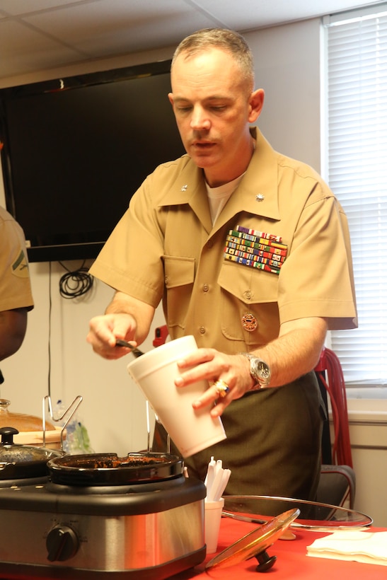 Lt. Col. Harry L. Gardner, commanding officer of Headquarters and Support Battalion, fills a cup with his home-made chili at the H&S Bn. chili cook-off aboard Marine Corps Base Camp Lejeune, recently.