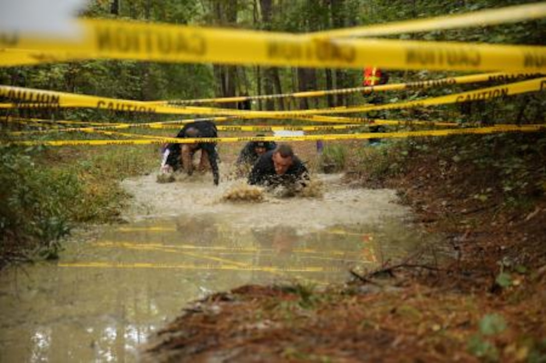 Marines finish crawling out of the mud pit during Marine Corps Air Station Cherry Point’s All Terrain Unit Competition Oct. 25 at Cherry Point’s Piranha Pit. The Marines escaped from the pit but quickly faced an unexpected zombie attack.