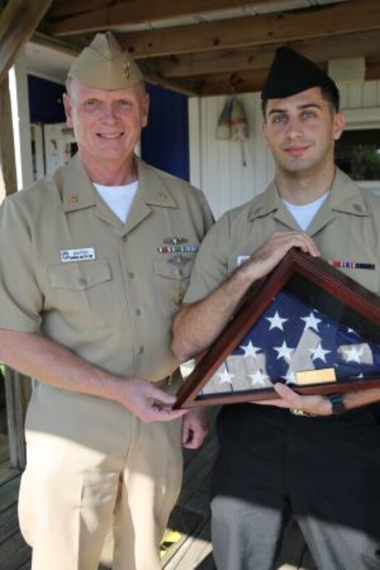 Master Chief Glenn Baxter (left) presents Seaman Bobby C. Kieff Jr. (right) with an encased American Flag after Kieff was recognized as the Carteret County Military Affairs Committee Service Person of the Quarter at a ceremony Friday. Kieff is a hospital corpsman working in the physical therapy department of the Naval Health Clinic at Cherry Point. Baxter is the command master chief of Naval Health Clinic Cherry Point.


