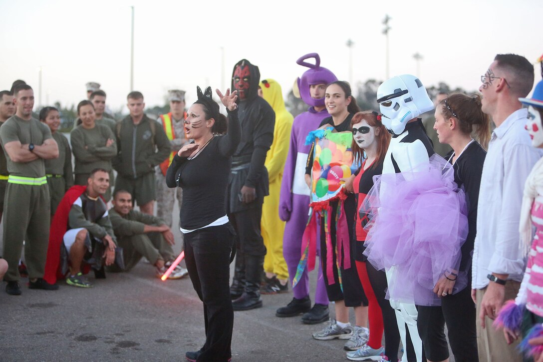 Gunnery Sgt. Joanna H. Mendoza, Headquarters Company gunnery sergeant, Combat Logistics Regiment 17, 1st Marine Logistics Group, holds a costume competition at the end of a Halloween-themed physical training circuit aboard Camp Pendleton, Calif., Oct. 30, 2013. The event's festivities built camaraderie and provided the Marines with an opportunity to unwind and have fun with their peers. 